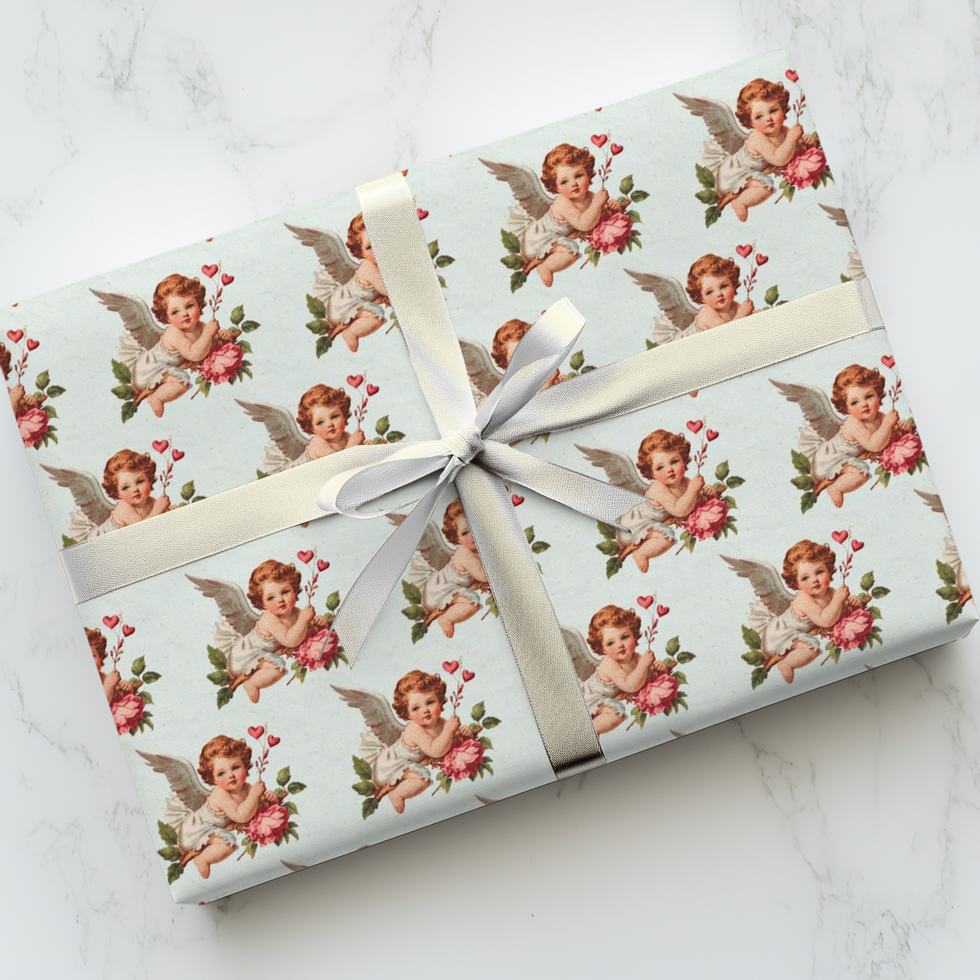 Vintage Valentine’s Day wrapping paper with Cupid angel and hearts on pale blue background