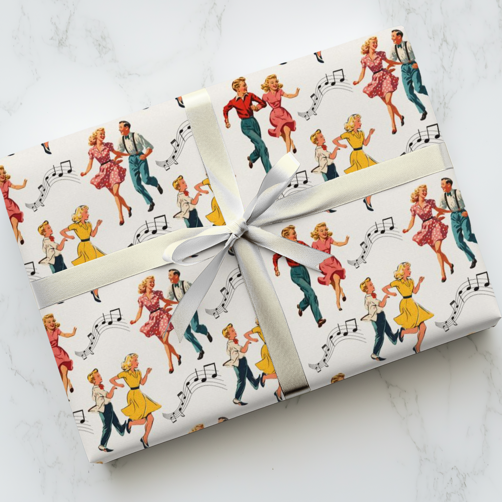 Gift wrapped in retro-themed paper with dancing couples and music notes on a white marble surface.