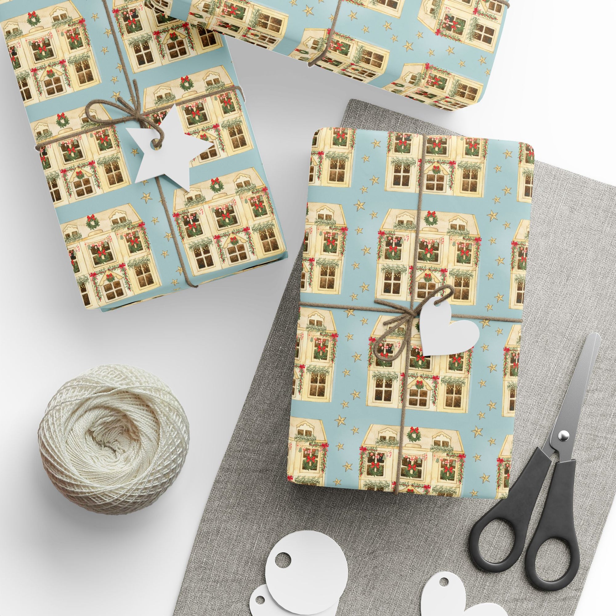 Charming dollhouse-themed Christmas wrapping paper with golden stars on a table