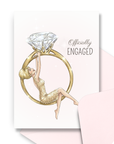 Engagement card for bride to be with blonde bride swinging from large diamond ring illustration with coordinating pink envelope.