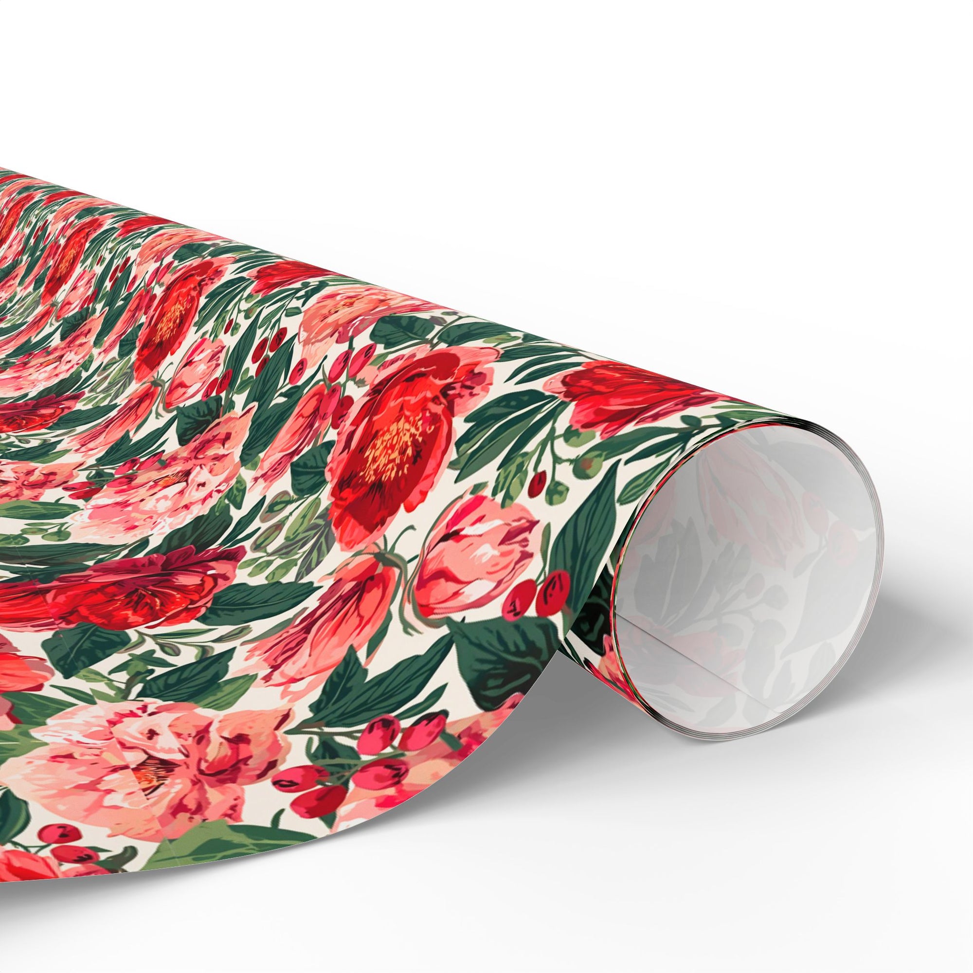Roll of floral rose and peony wrapping paper in red and blush pink with greenery for Christmas, weddings and birthdays.