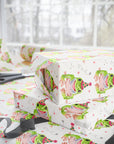Birthday wrapping paper with green frog wearing a party hat and small decorative details.