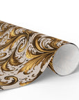Wrapping paper roll of gold and gray scroll patterned paper on a white background