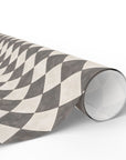 Roll of patterned paper with geometric design on a white background