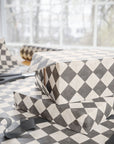 Gift wrapping paper with geometric pattern on a checkered surface