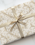 Gilded Age inspired ivory floral wrapping paper with ornate vintage scroll pattern with flowers wrapped on elegant gift boxes.