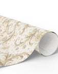 Roll of decorative paper with intricate gold and beige pattern on a white background