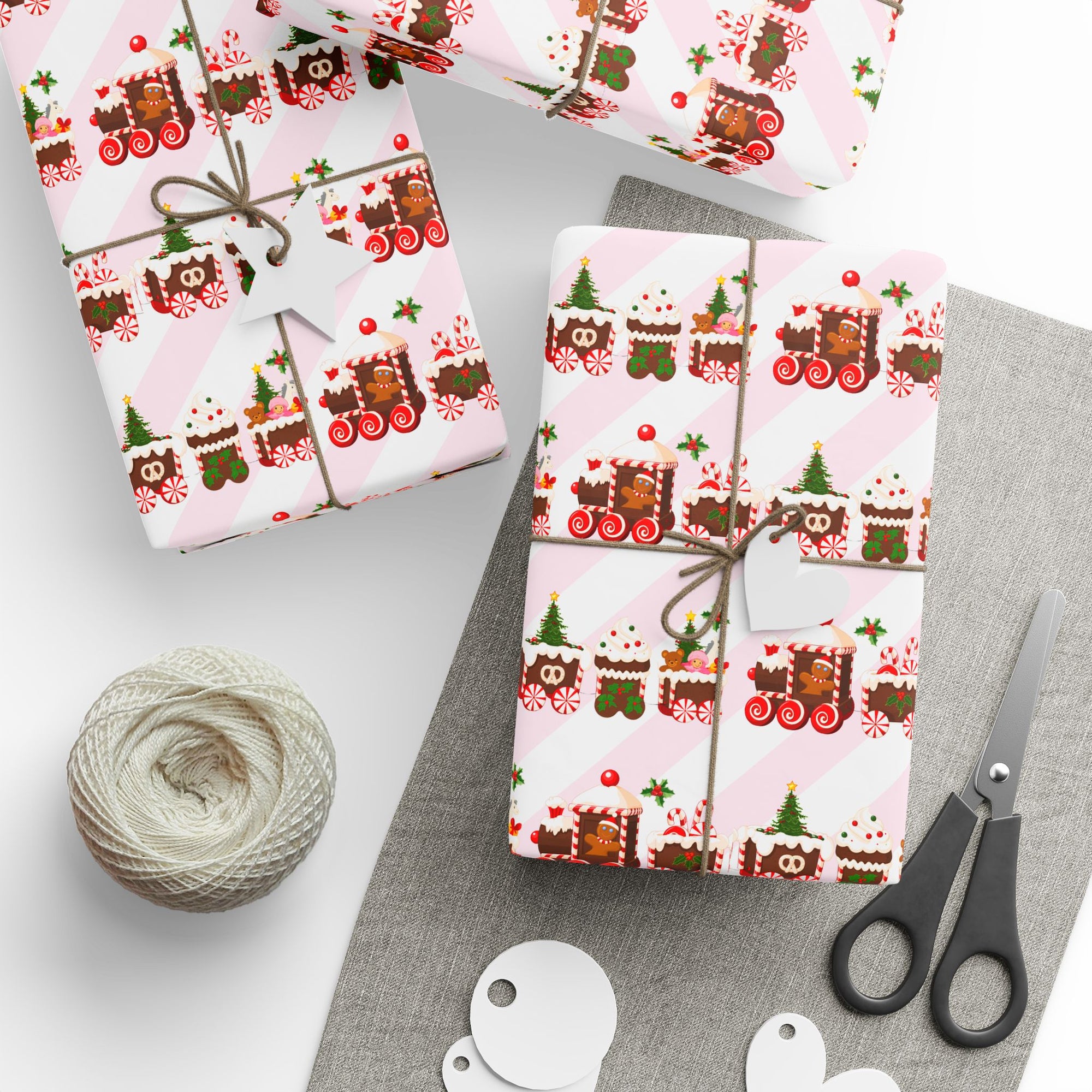 Gift box with a gingerbread Christmas train wrapping paper on table with tape