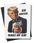 A greeting card with an illustration of the president in a movie-like pose with a gun, and the text  'MAKE MY DAY'