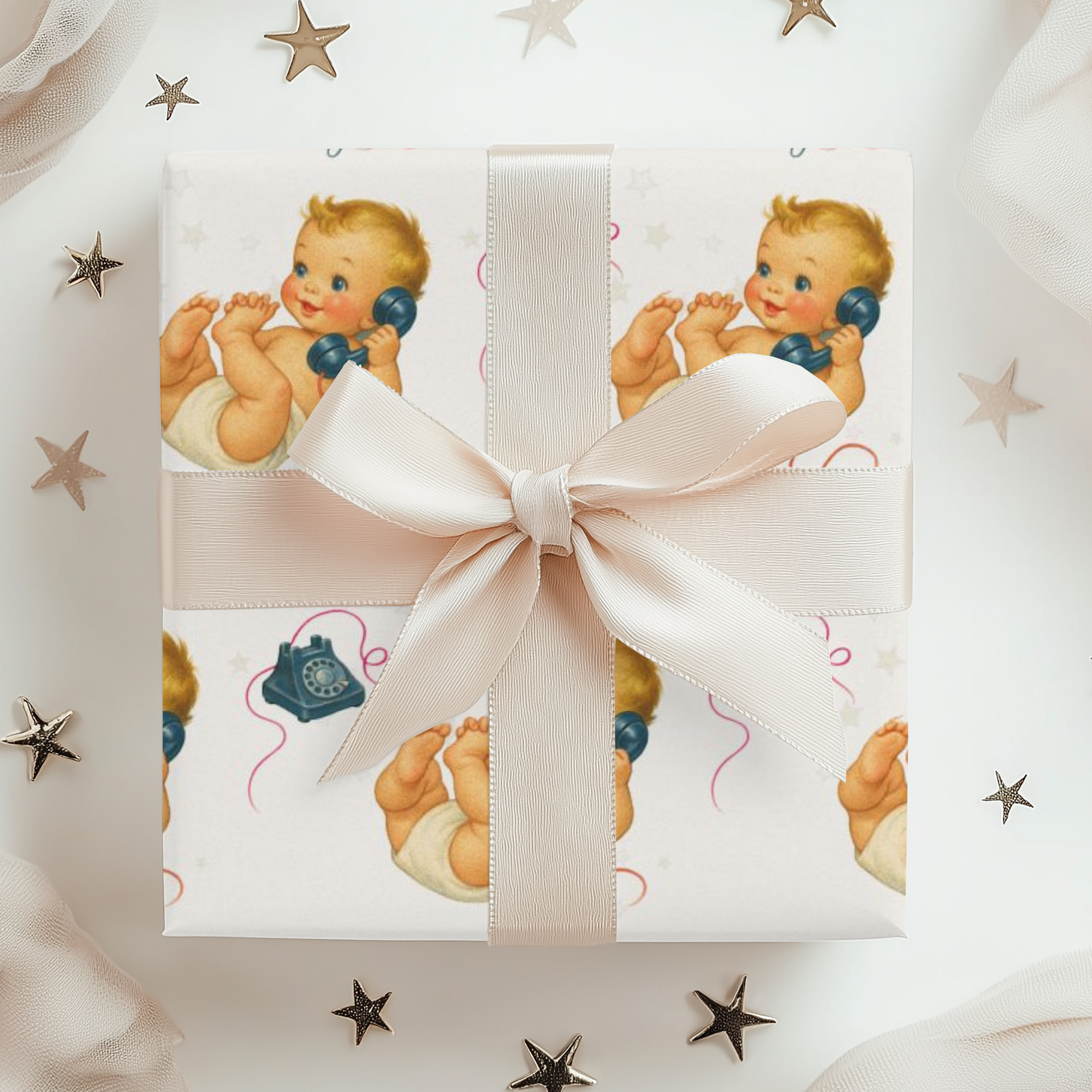 Gift box with a ribbon and baby-themed wrapping paper featuring illustrations of babies and stars.