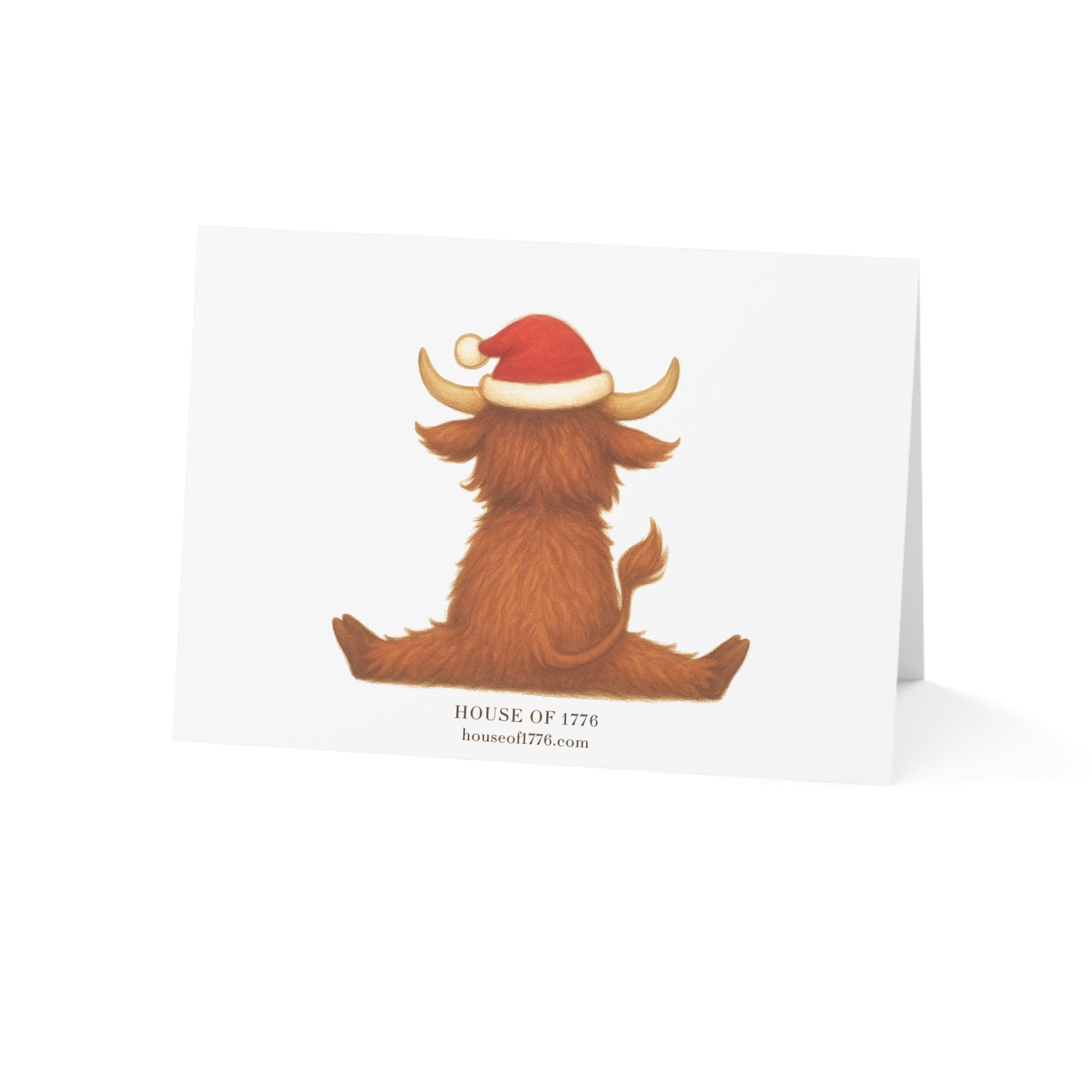 Card with a highland bull wearing a Santa hat on a white background