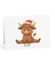 Card with a highland cow wearing a Santa hat and the word 'SLAY' on a white background