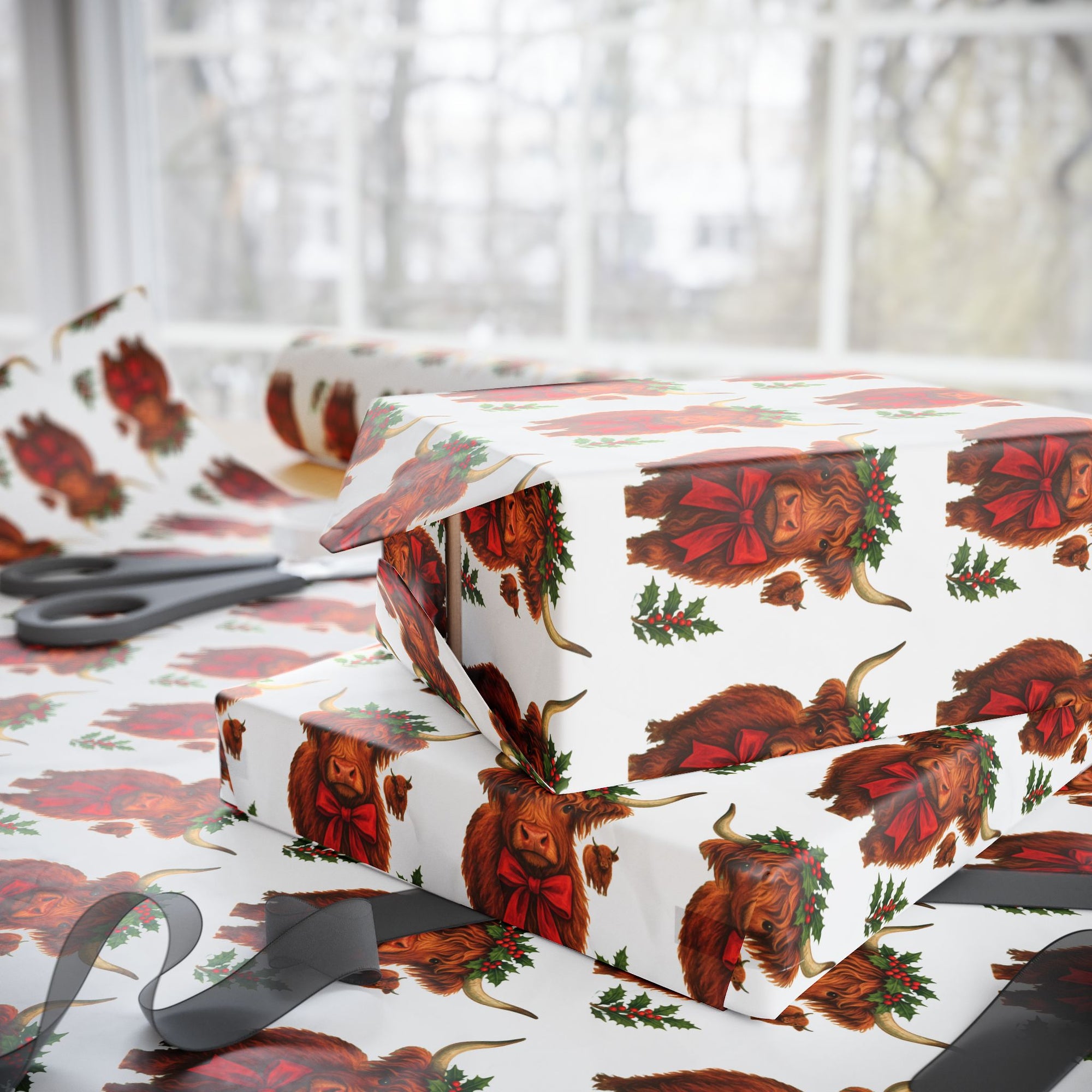 Gift boxes wrapped in highland cow patterned paper with scissors on a white background