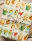 Vintage mid-century holiday cocktail wrapping paper featuring martinis, candy canes, and snowmen in watercolor style.