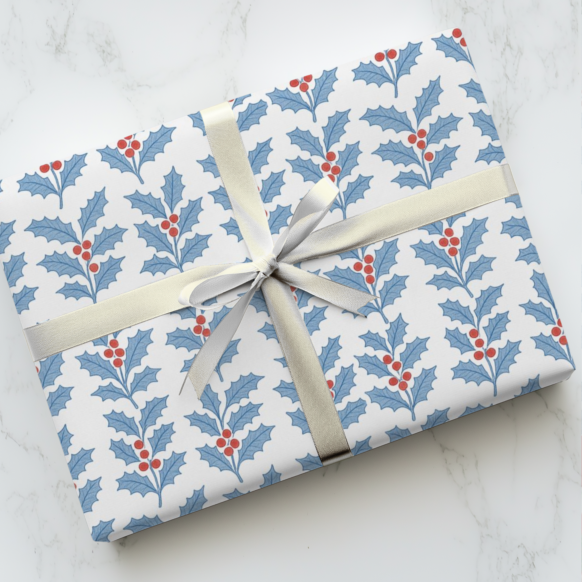 Christmas wrapping paper featuring red white and blue holly-pattern.