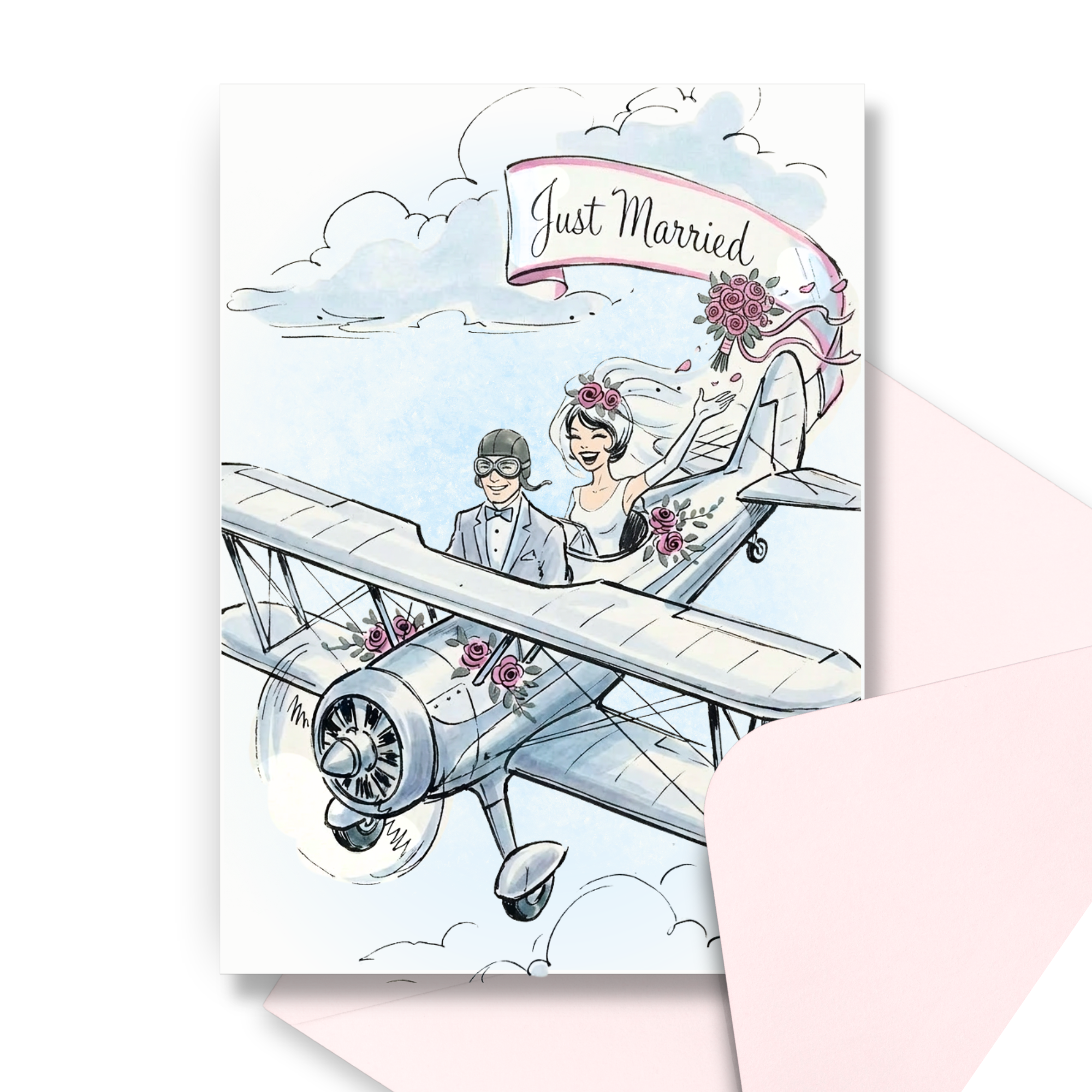 Vintage wedding greeting card with bride and groom flying in a biplane with Just Married banner trailing behind. A pink envelope is laying in the background.