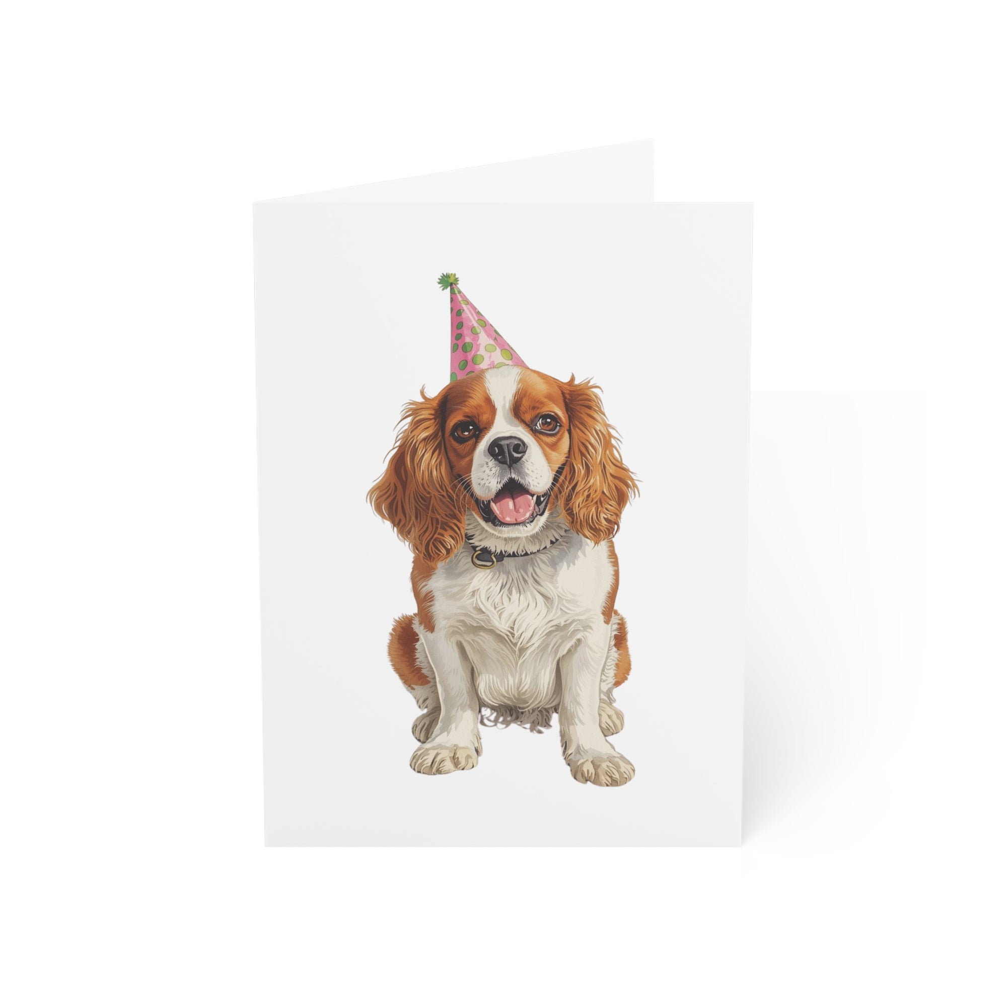 King Charles Cavalier dog wearing a party hat on a white birthday card