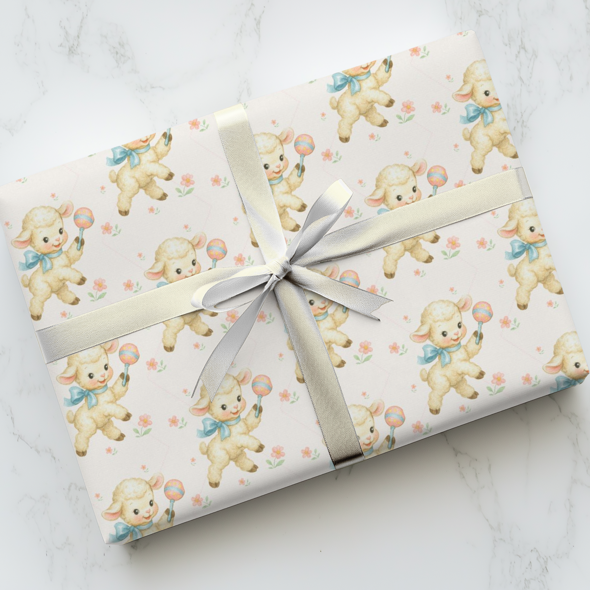 Gift wrapped in paper with lamb pattern on a marble surface