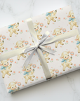 Gift wrapped in paper with lamb pattern on a marble surface