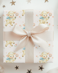 Gift box with lambs and pink ribbon on a white background with star decorations