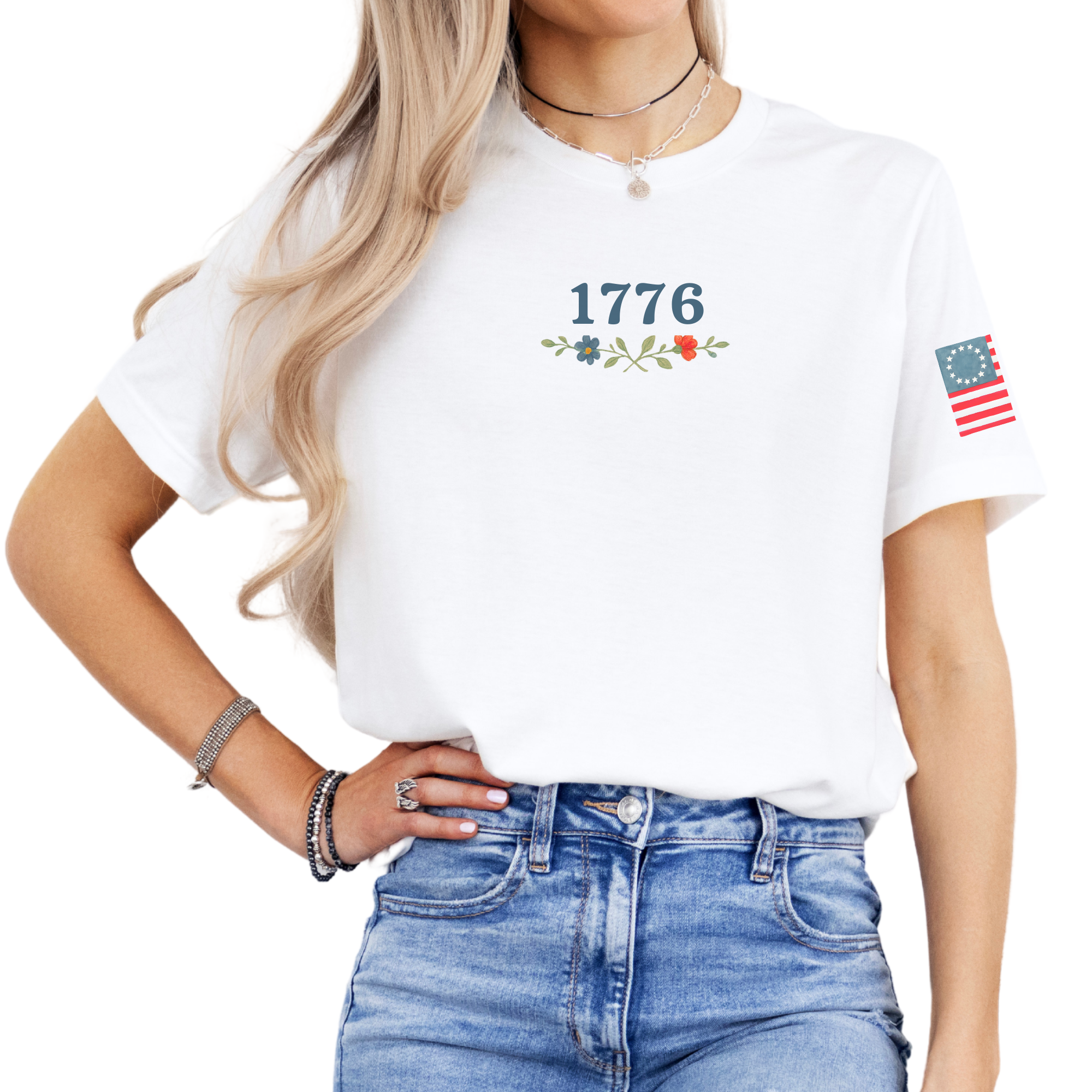 Woman wearing a white t-shirt with a graphic design 1776 and floral elements front view