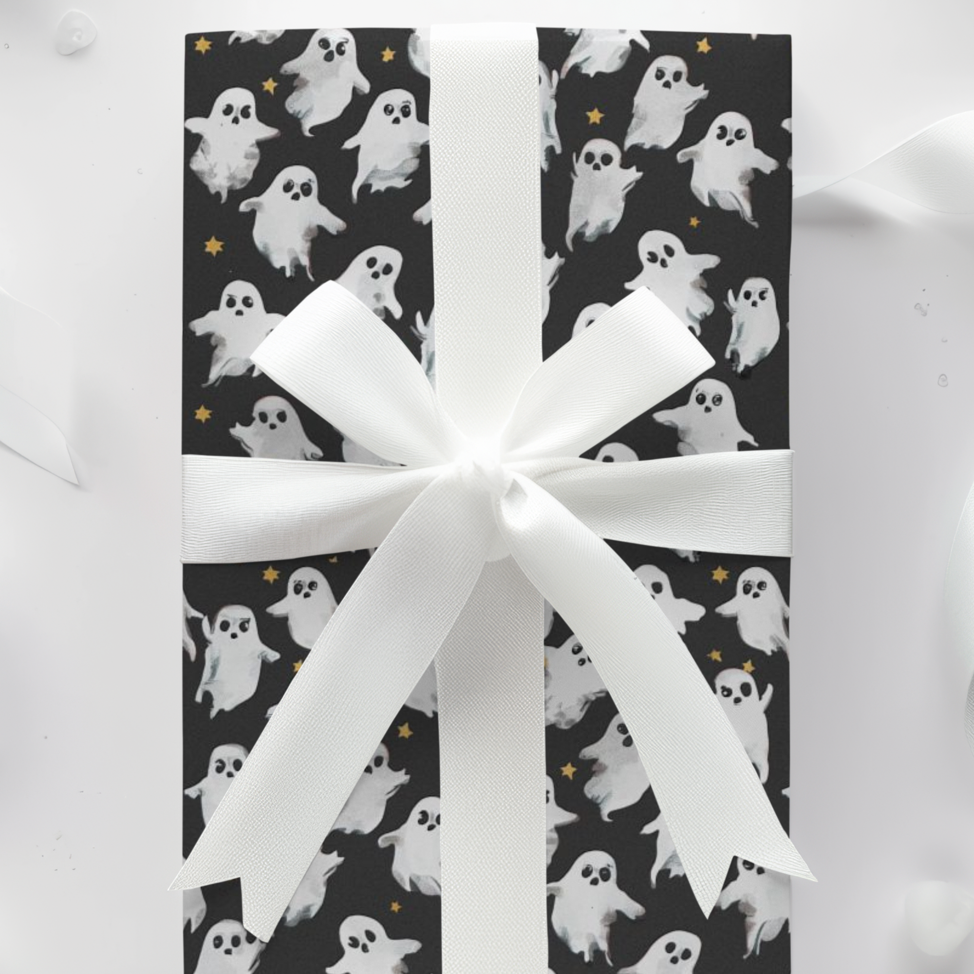 Vintage Halloween wrapping paper featuring white ghosts and golden stars on dark background