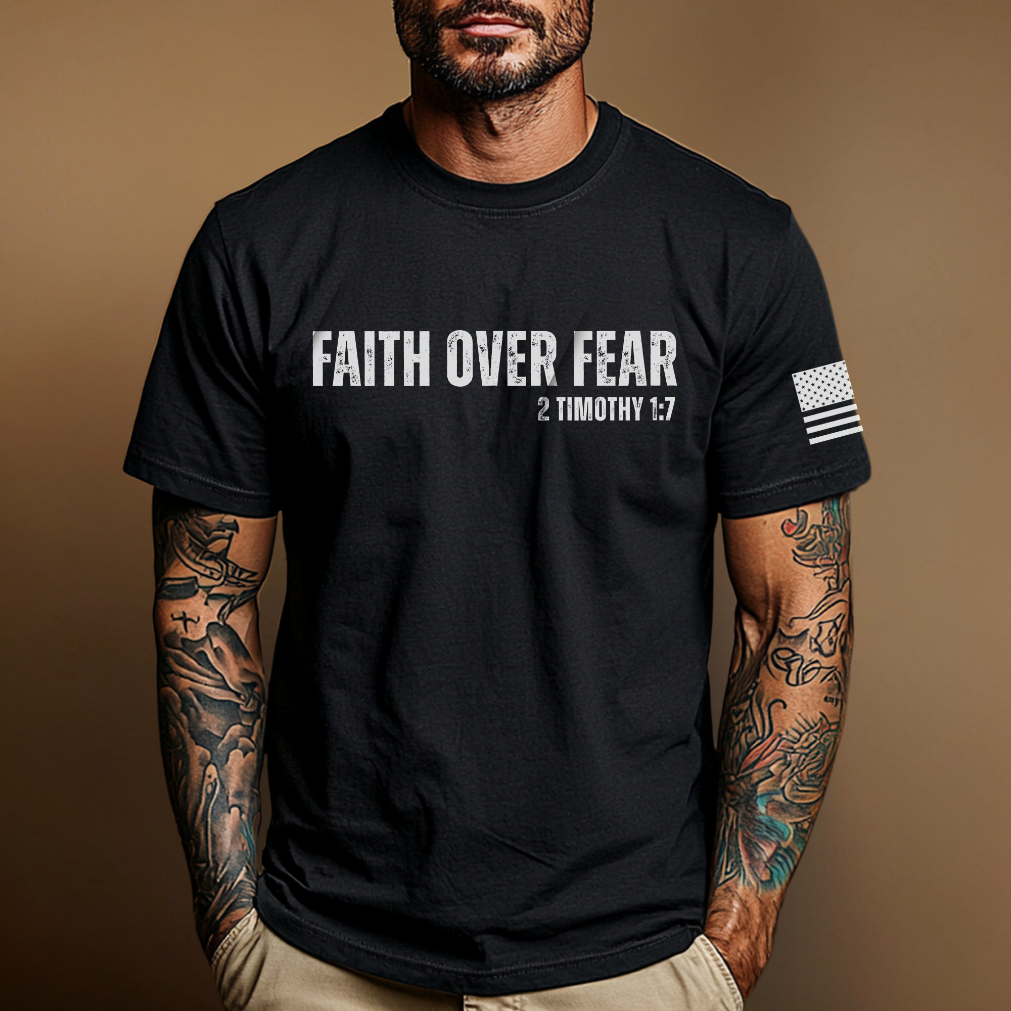 Man wearing a black t-shirt with 'faith over fear'' text and bible verse '2 timothy 1:7