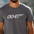 man wearing a gunmetal color t-shirt with '0047' printed  in white across the front