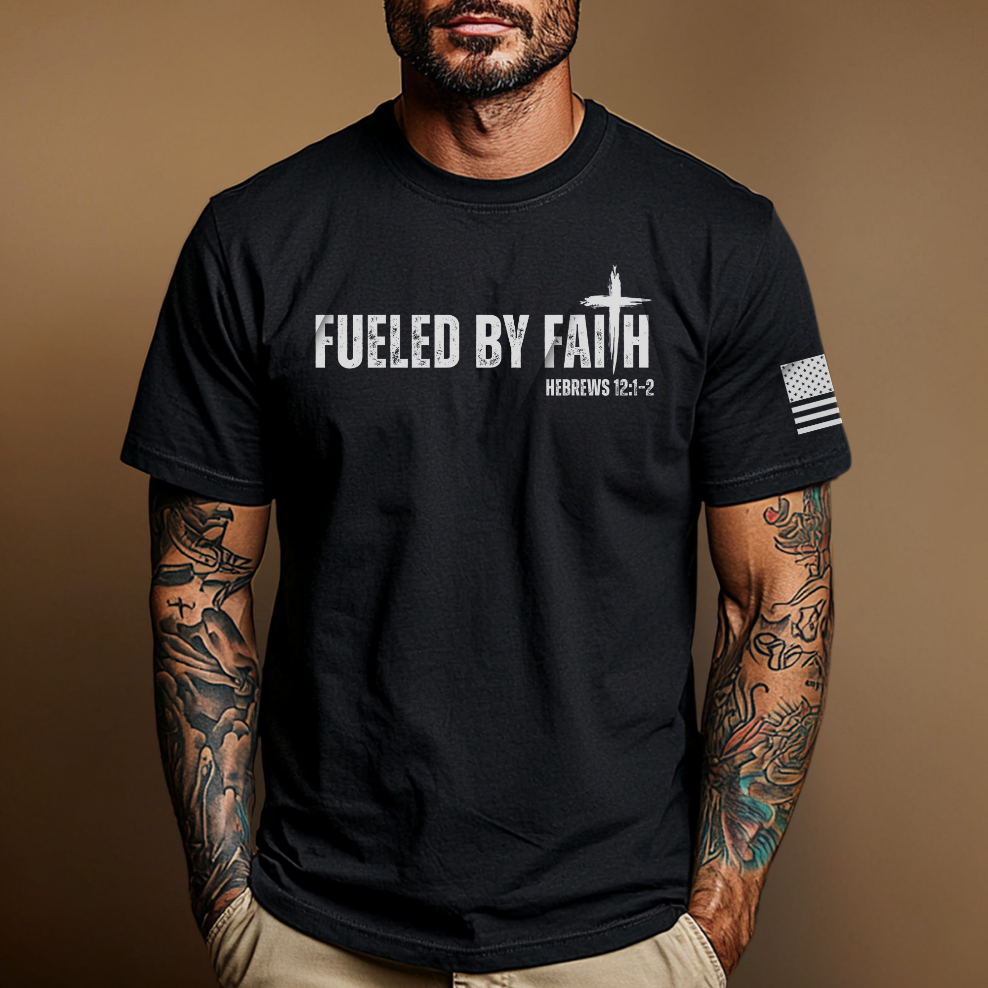 Man wearing a black t-shirt with 'Fueled by faith'' text and bible verse 'Hebrew 12:1-2