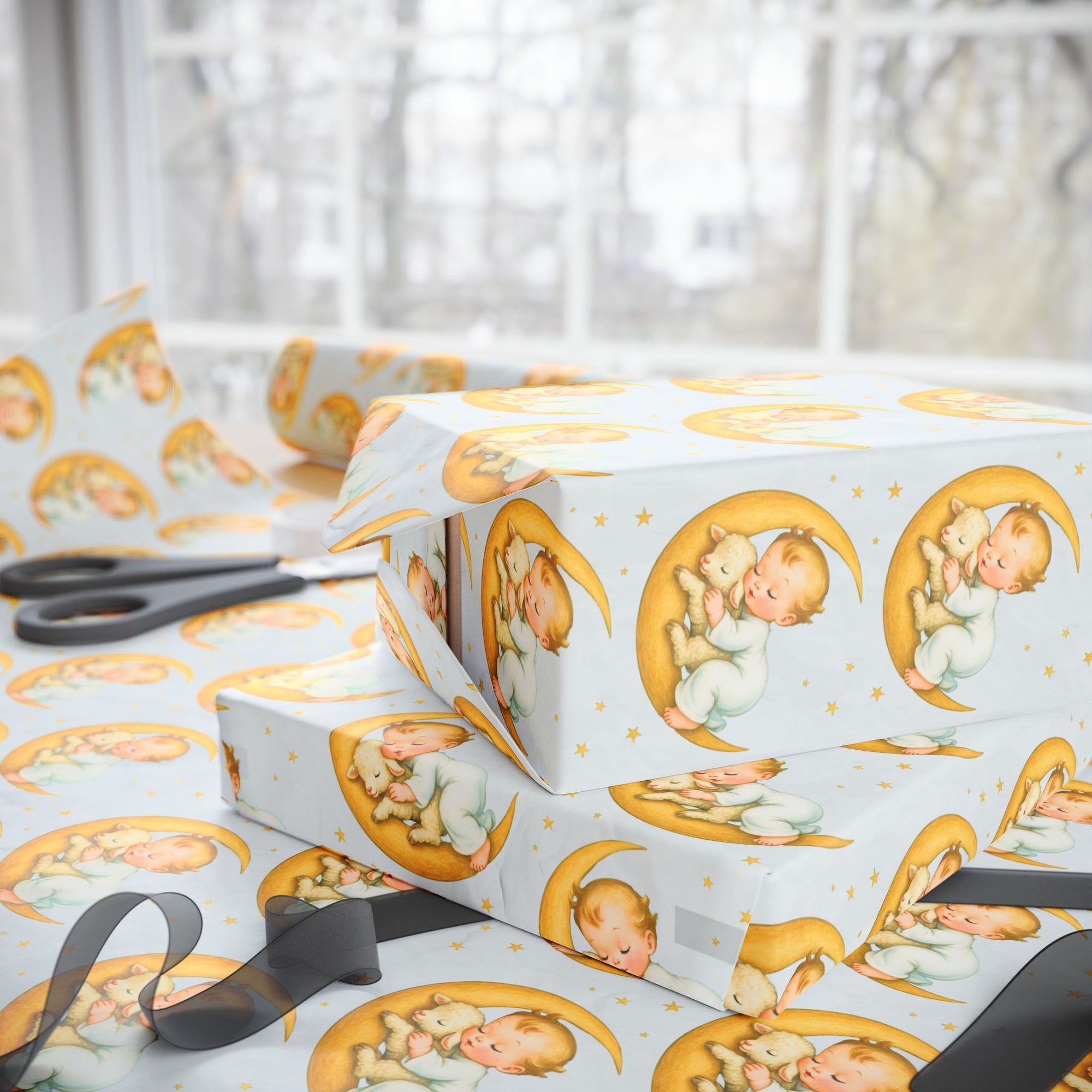Gift boxes wrapped in paper with baby lamb and moon designs, scissors on a light background