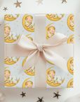 Gift box wrapped with patterned paper and a bow, surrounded by decorative stars.