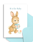 Baby shower card with a bunny holding a block that says 'B' on a white background.