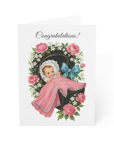 Baby shower card with a vintage-style illustration of a baby in a crib surrounded by flowers and the word 'Congratulations'.