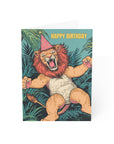 Birthday card with a lion wearing a party hat and the text 'Happy Birthday' on a tropical leaf background.