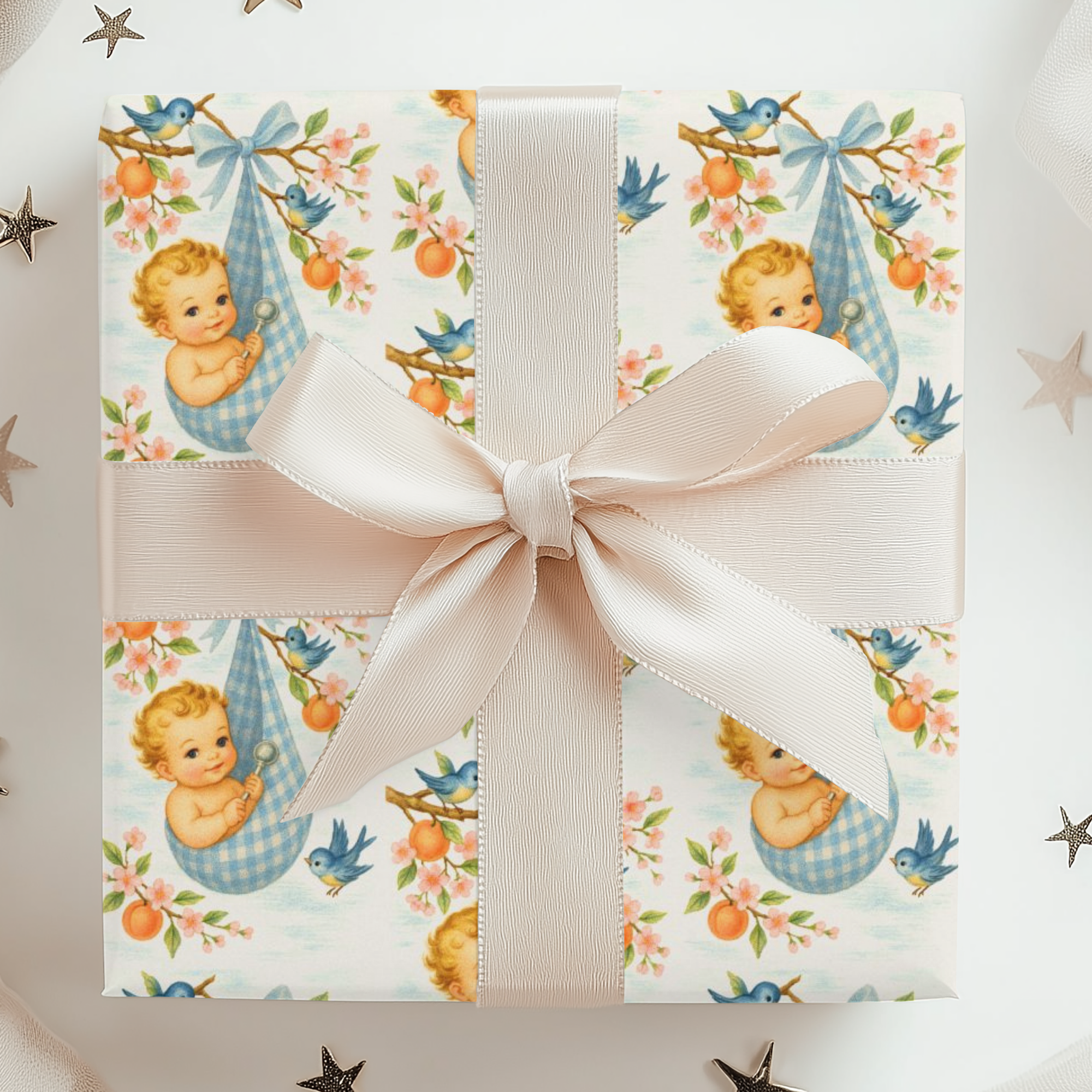 Gift wrapped in vintage-esque baby design of little boy wrapped in blue gingham hanging from a tree.