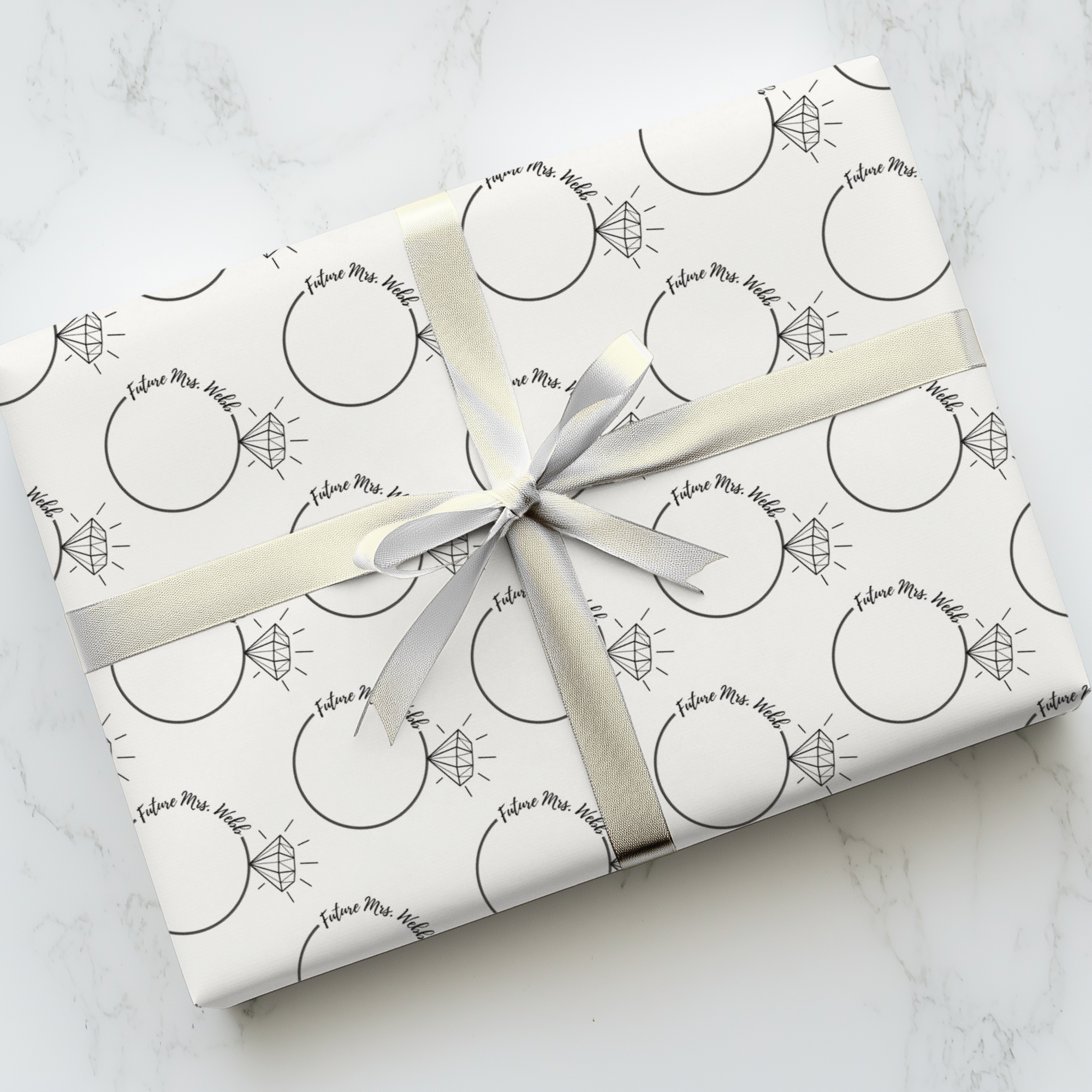 Personalized bridal shower wrapping paper with future Mrs name and engagement ring pattern.