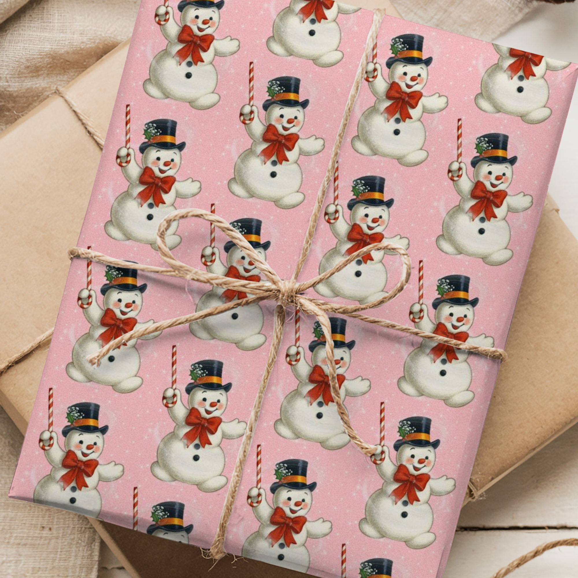 Pink christmas wrapping paper with asnowman pattern.