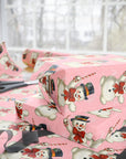 pink wrapping paper with snowman and peppermint candy canes