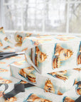 Gift wrapped in paper with Pomeranian dog illustrations and a cake and candles