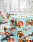 Darling aqua color wrapping paper featuring a retro poodle with a santa cap and snow falling gently in the background. 