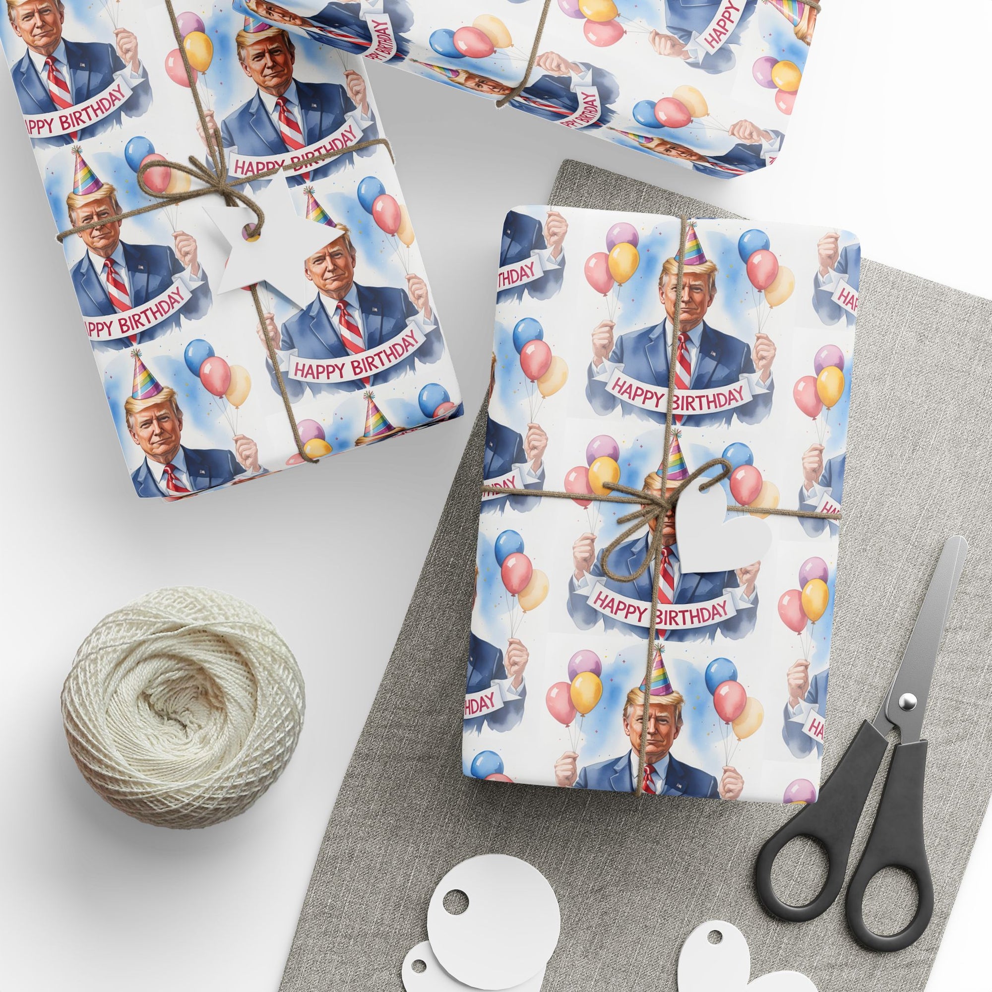 Gift wrap with a birthday-themed design featuring POTUS in a suit carrying  balloons and a birthday banner top