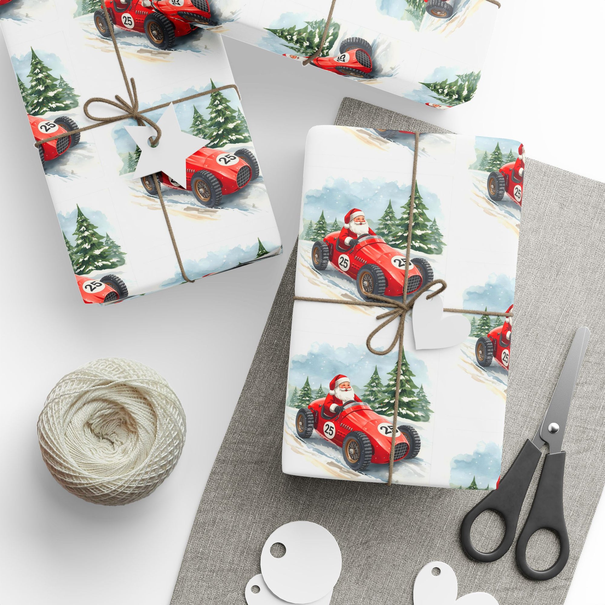 Gift wrap with Santa driving a red race car design, tied with twine, on a gray surface with scissors and string.