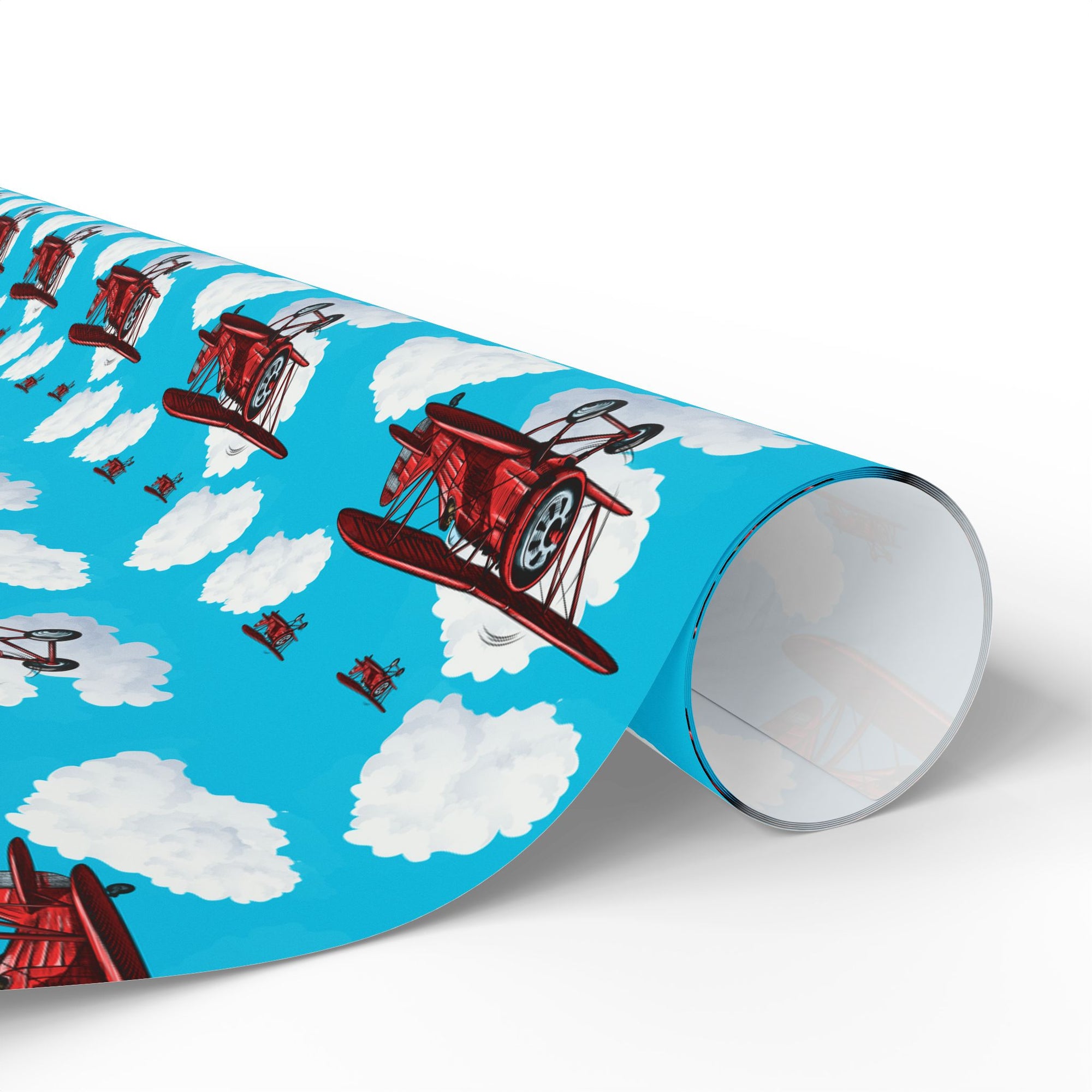 Wrapping paper with a pattern of red biplanes flying through a blue sky with white clouds.