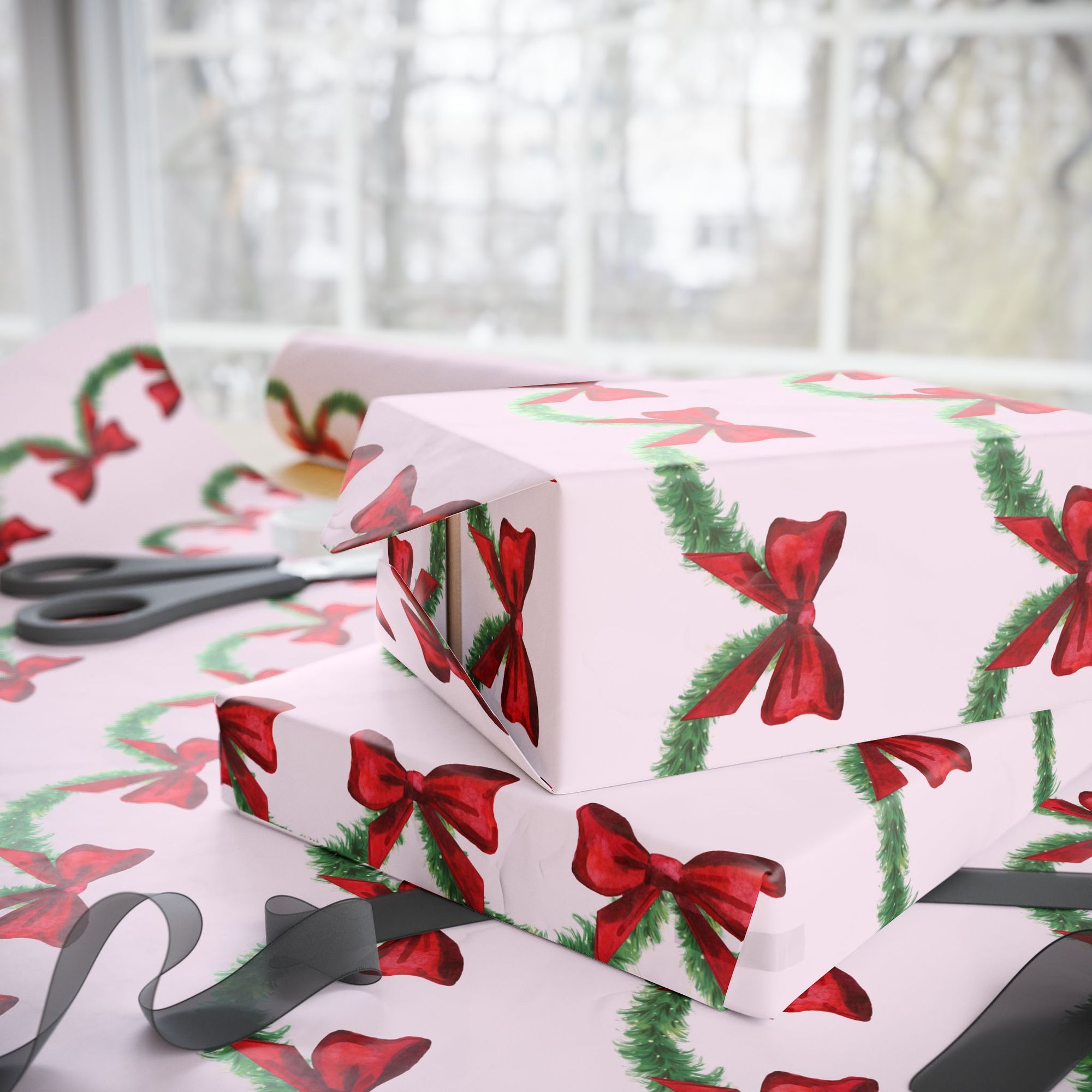 Christmas-themed wrapping paper with red bows and green garland on a pink background side view