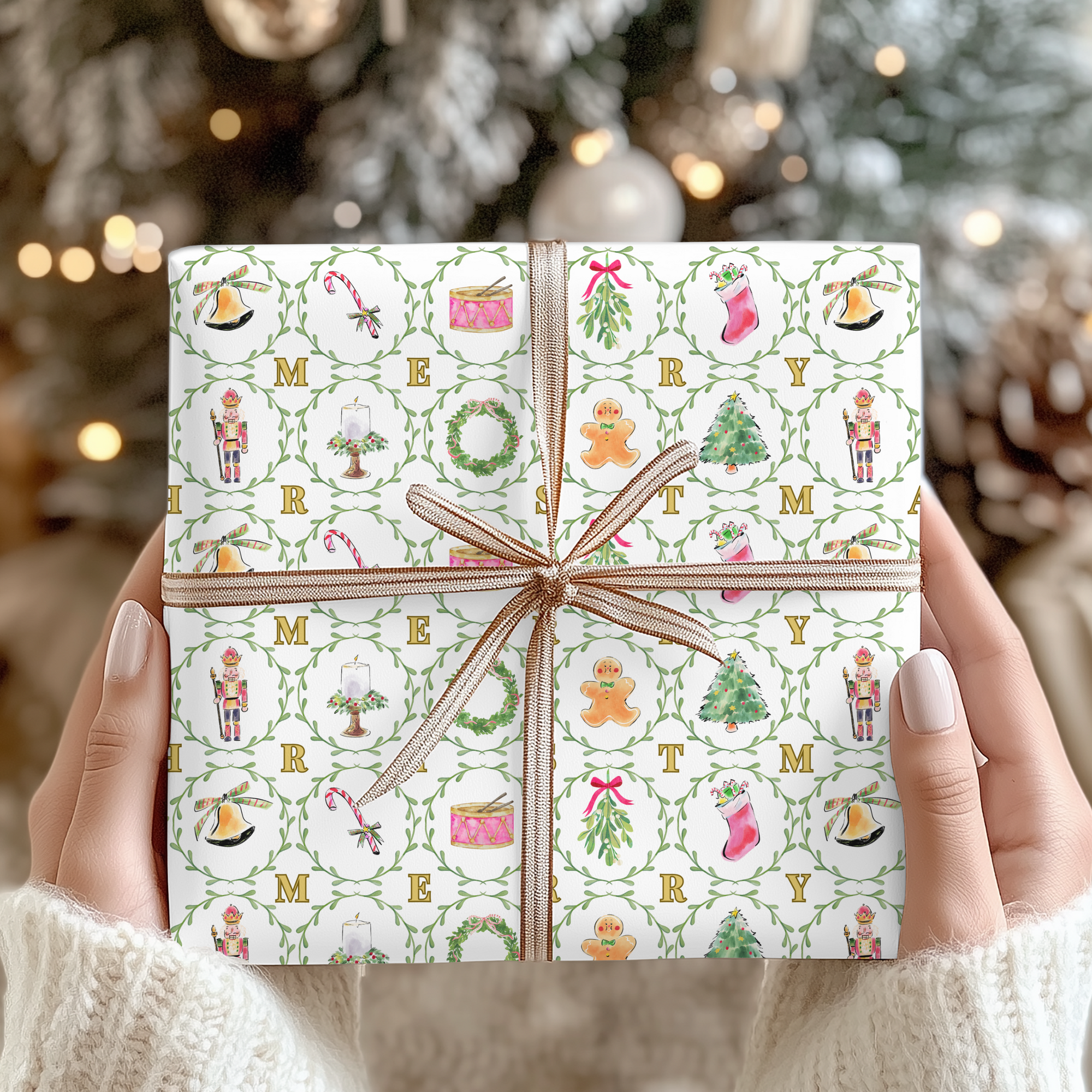 Gift wrapped in festive paper with Christmas-themed illustrations held by hands against a blurred Christmas tree background.