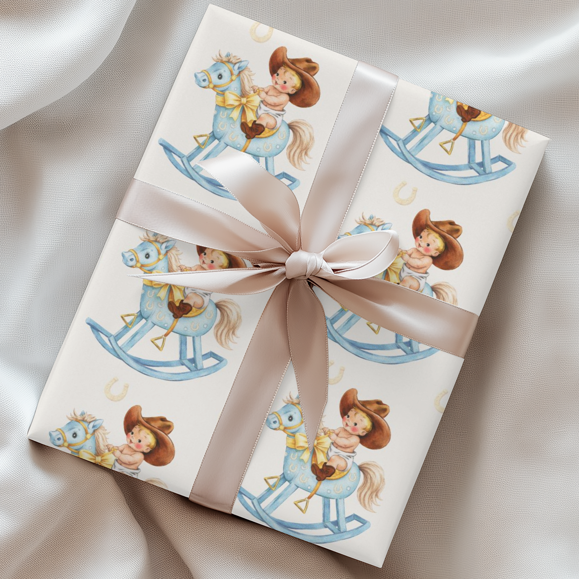 Gift wrapped in paper with a child's illustration of a baby on a rocking horse, tied with a ribbon.