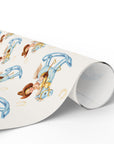 Roll of wrapping paper with vintage-style illustrations of a western baby on a rocking horse.