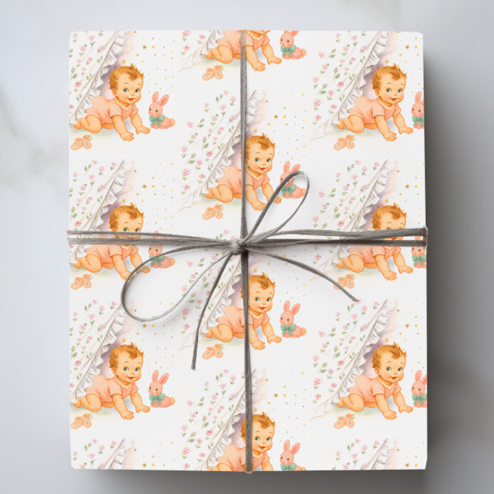 baby shower wrapping paper roll with rosy-cheeked baby and plush bunny