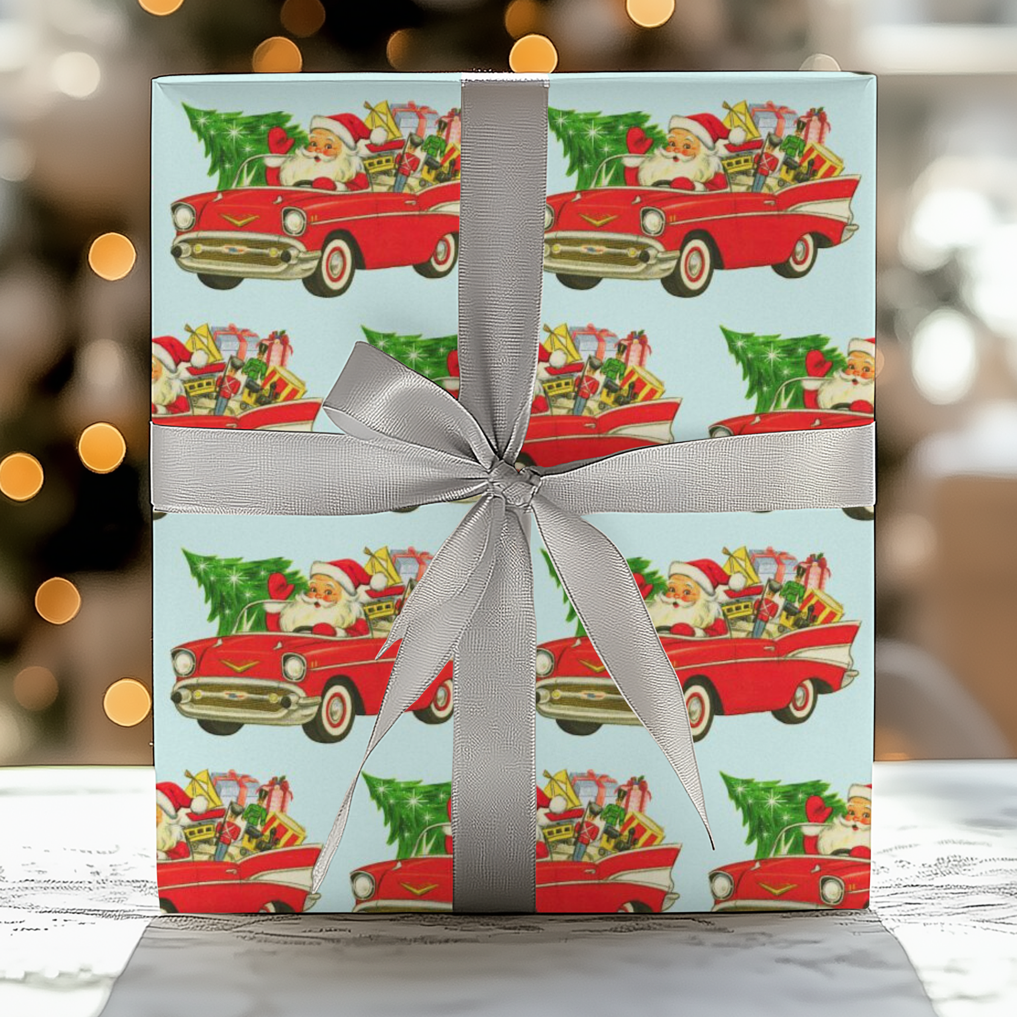 Retro holiday wrapping paper featuring Santa in a 1957 Chevy with gifts and Christmas tree.