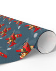 Christmas wrapping paper with Santa flying a vintage red airplane in snowy night sky.